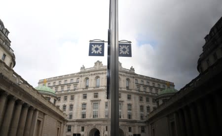 FILE PHOTO: The logo of RBS bank is seen reflected in the windows of a branch of the bank in the City of London financial district in London