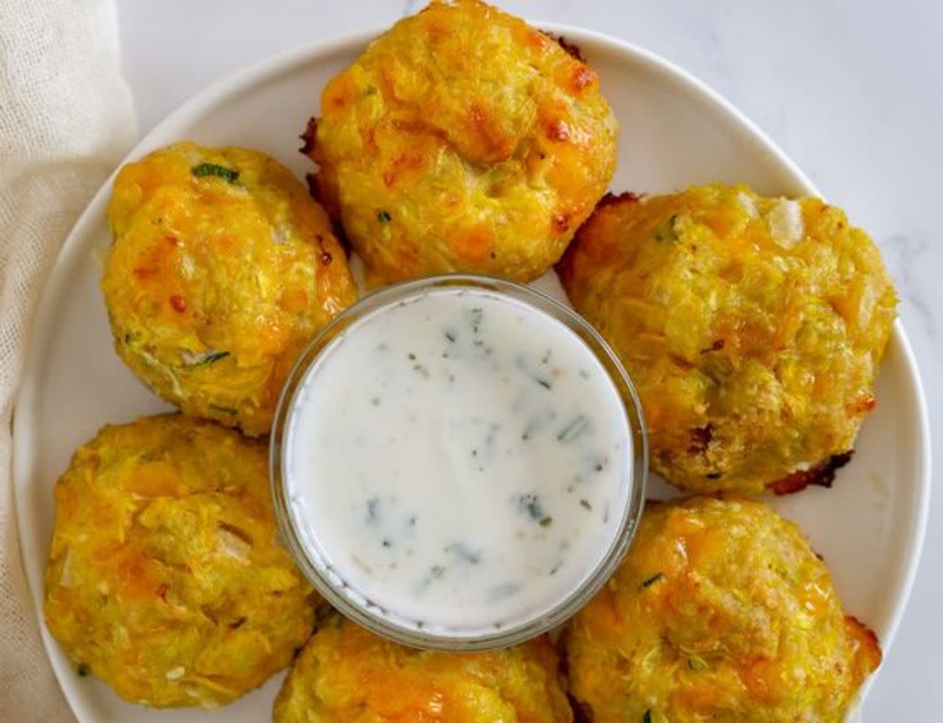 <p>Babaganosh</p><p>Looking for a fun summer squash recipe? Make these yellow squash tater tots- perfect little veggie tots that use up a lot of yellow squash (or zucchini!).</p><p><strong>Get the recipe: <a href="https://www.babaganosh.org/yellow-squash-tots/" rel="nofollow noopener" target="_blank" data-ylk="slk:Yellow Squash Tots with Garlicky Sauce;elm:context_link;itc:0;sec:content-canvas" class="link rapid-noclick-resp">Yellow Squash Tots with Garlicky Sauce</a></strong></p>