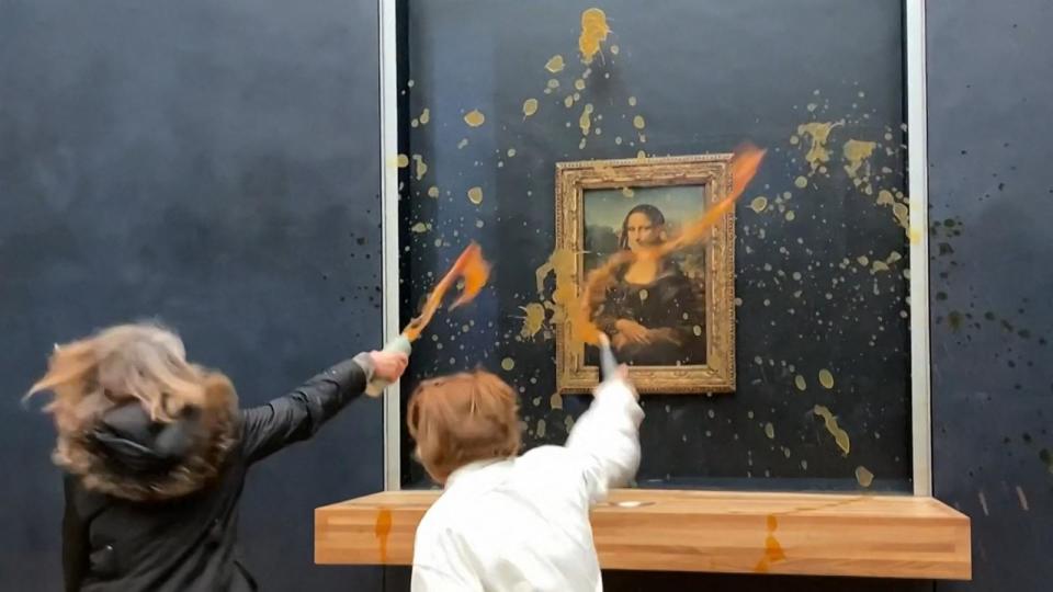 PHOTO: This image grab taken from AFPTV footage shows two environmental activists from the collective dubbed 'Riposte Alimentaire' hurling soup at Leonardo Da Vinci's 'Mona Lisa' (La Joconde) painting, at the Louvre museum in Paris, on Jan. 28, 2024. (David Cantiniaux/AFPTV/AFP via Getty Images)