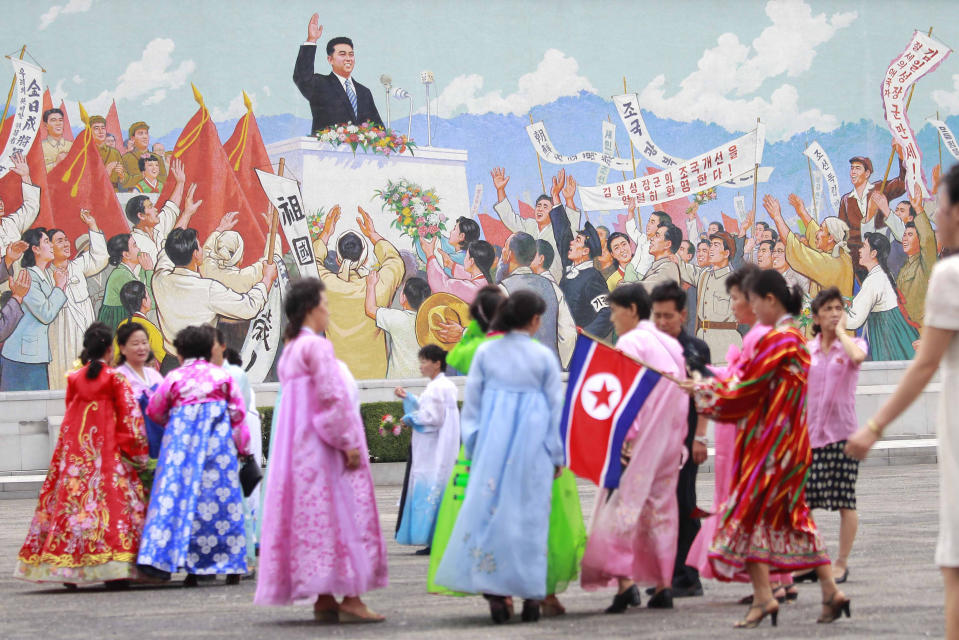 Citizens celebrate the in the plaza of the Arch of Triumph dressing in traditional costume to commemorate the 77th anniversary of Korea's Liberation in Pyongyang, North Korea, Monday, Aug. 15, 2022. (AP Photo/Cha Song Ho)