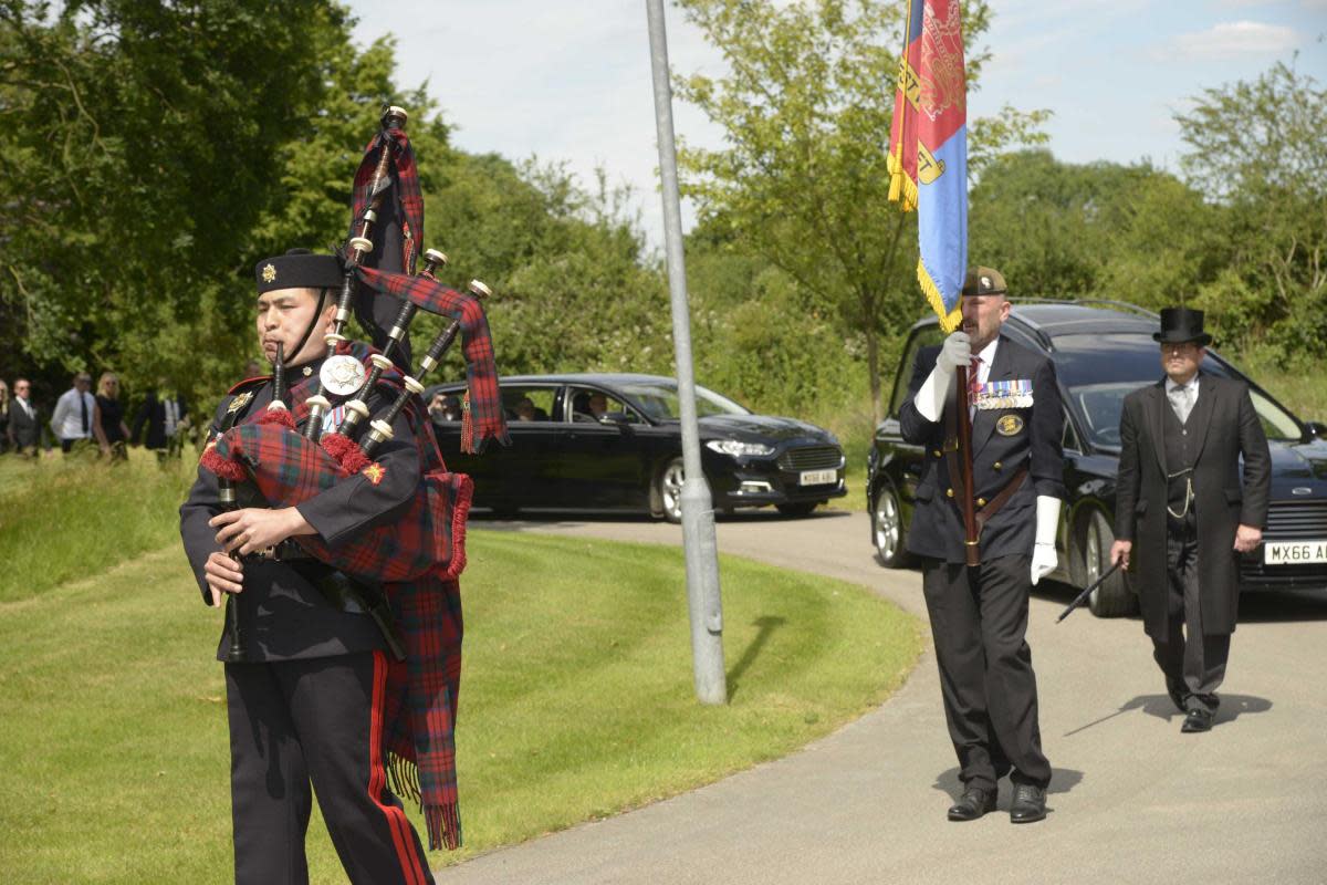 A piper with the 9th Regiment of the Royal Logistic Corps leads the cortege at the funeral of Normandy Veteran Allan Gullis. <i>(Image: Trevor Porter 77148-1)</i>