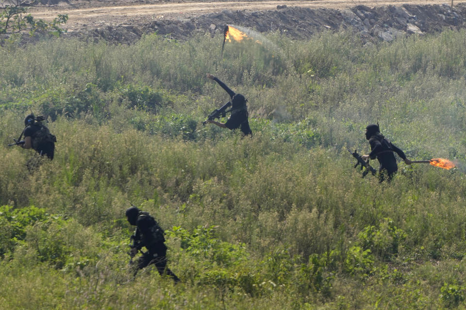 Participants playing the role of terrorists attack a United Nations base during the Shared Destiny 2021 drill at the Queshan Peacekeeping Operation training base in Queshan County in central China's Henan province Wednesday, Sept. 15, 2021. Peacekeeping troops from China, Thailand, Mongolia and Pakistan took part in the 10 days long exercise that field reconnaissance, armed escort, response to terrorist attacks, medical evacuation and epidemic control. (AP Photo/Ng Han Guan)