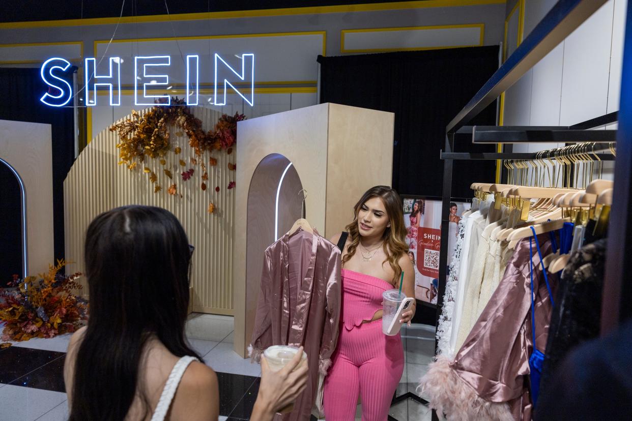 Shoppers Ashley Sanchez, right, of Fontana, and Joscelin Flores are among the first group of shoppers taking the opportunity to shop on the opening day of fast fashion e-commerce giant Shein, which is hosting a brick-and-mortar pop up inside Forever 21 at the Ontario Mills Mall in Ontario Thursday, Oct. 19, 2023.