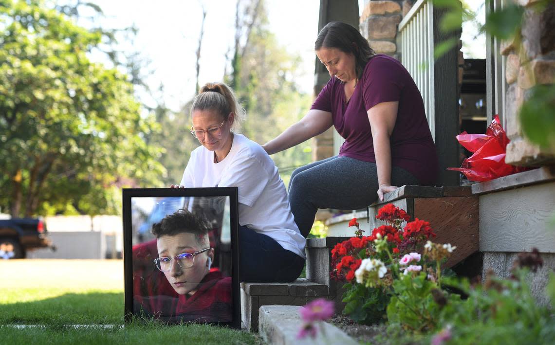 Amber Weilert is comforted by her sister, Autumn Shafer, as she sits with a photo of her son, Michael Weilert, at the family’s home in Parkland on July 27, 2022. The 13-year-old was killed July 19 when he was hit by a car while riding his bicycle through a crosswalk near his home.