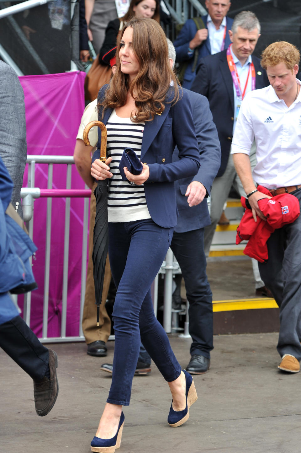 Kate’s navy blazer, pants, wedges, and clutch could easily be dull but her striped shirt pulls it together. We also can't help but notice that the umbrella is one her best unintentional accessories. Here the Duchess walks to her seat prior to the Show Jumping Eventing Equestrian on Day 4 of the London Games.