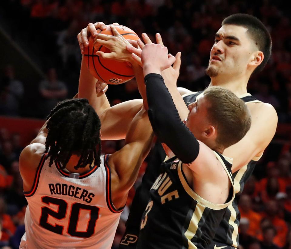 Illinois Fighting Illini forward Ty Rodgers (20), Purdue Boilermakers guard Braden Smith (3) and Purdue Boilermakers center Zach Edey (15) fight for a rebound during the NCAA men’s basketball game, Tuesday, March 5, 2024, at State Farm Center in Champaign, Ill. Purdue Boilermakers won 77-71.
