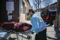 Employees deliver a body at Daniel J. Schaefer Funeral Home, Thursday, April 2, 2020, in the Brooklyn borough of New York. The company is equipped to handle 40-60 cases at a time. But amid the coronavirus pandemic, it was taking care of 185 Thursday morning. (AP Photo/John Minchillo)