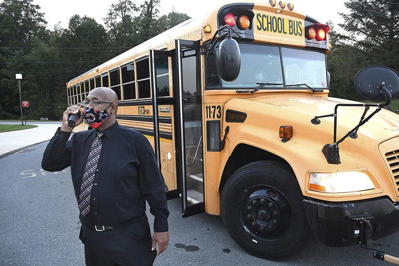 Beckley Stratton Middle School principal Yahon Smith monitors school buses and parent drop off of students for the first day of school, Sept. 8, 2020, in Beckley. A group of Republican lawmakers is proposing a ban on mask mandates in K-12 schools.