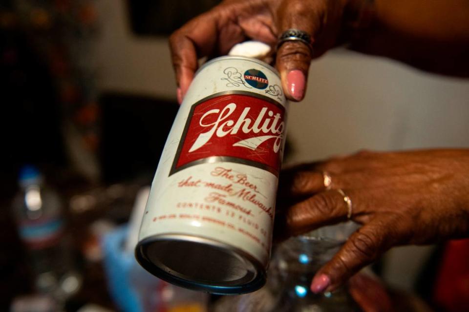 Mary Gipson holds up a vintage beer can that was found under Gipson’s house on School Street in Ocean Springs on Tuesday, Sept. 26, 2023. Gipson’s father built the house and owned other property around it.