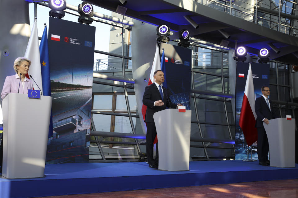 European Commission President Ursula von der Leyen, left, Polish President Andrzej Duda, center, and Poland's Prime Minister Mateusz Morawiecki, right, brief the media during a joint news conference at the headquarters of Poland's Power Grid in Konstancin-Jeziorna, Poland, Thursday, June 2, 2022. The independence of Poland's courts is at the heart of a dispute with the European Union, which has withheld billions of euros in pandemic recovery funds. European Commission President Ursula von der Leyen meets Poland's leaders discuss the matter. (AP Photo/Michal Dyjuk)