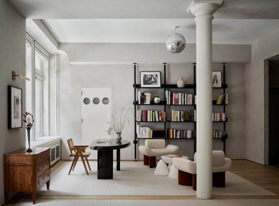 This cozy office and library is at the entrance to the apartment, next to the parlor. Schuster designed the asymmetric lacquered table and chose to pair it with a vintage Pierre Jeanneret chair. The modular floor-to-ceiling shelves were designed by Pieter Rams in 1960 and dubbed 606 Universal Shelving System; simple and versatile, they are a fitting backdrop to Giancarlo Valle’s whimsical “Smile” armchairs.