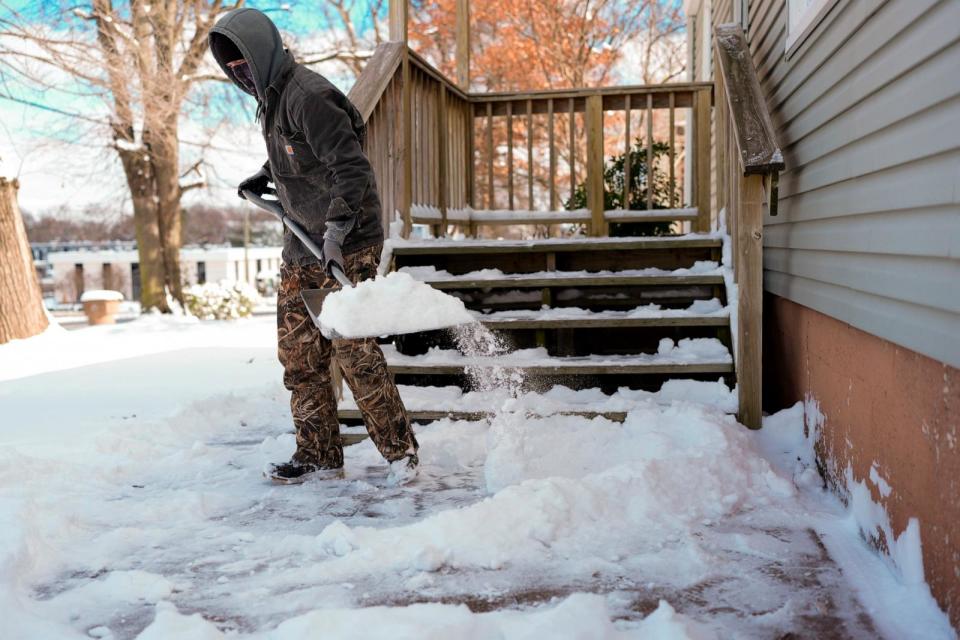 PHOTO: Jay Phillips shovels snow Tuesday, Jan. 16, 2024, in Nashville, Tenn. A snowstorm blanketed the area with up to eight inches of snow and frigid temperatures. (George Walker Iv/AP)