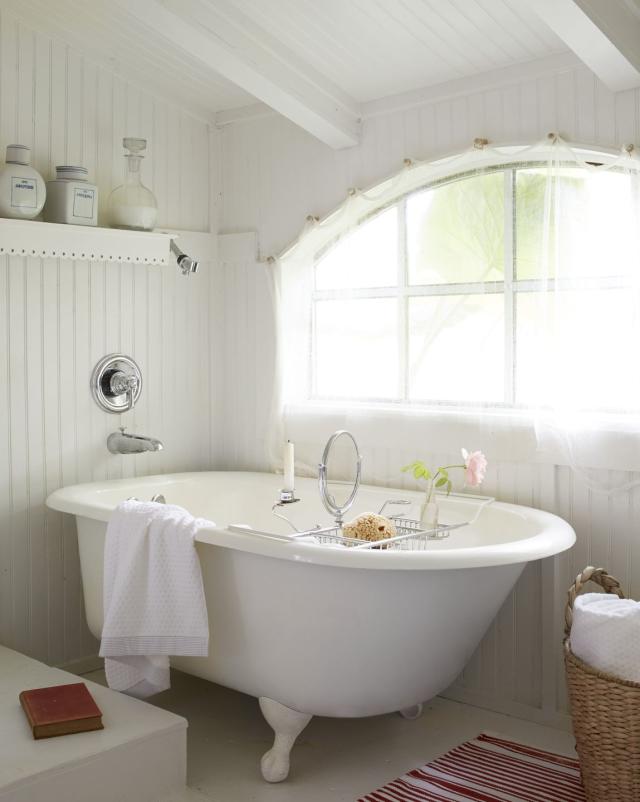 Bathroom Interior with Candles and a ClawFooted Tub · Creative Fabrica