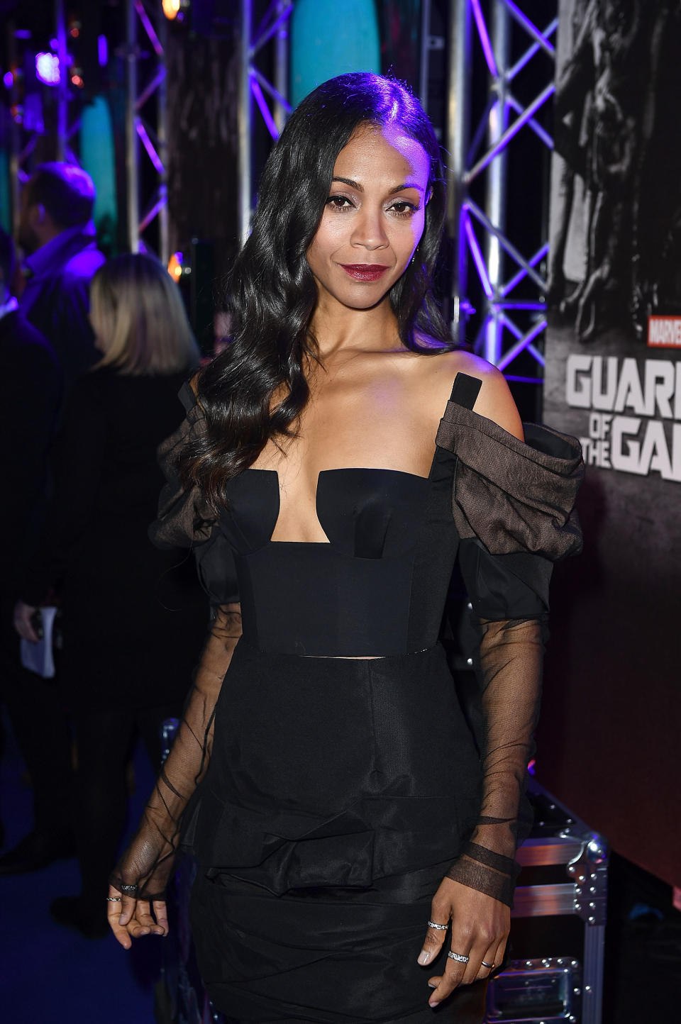 Zoe wearing a black shoulder-less dress with puffy black mesh sleeves. She is smiling at the Guardians of the Galaxy premiere