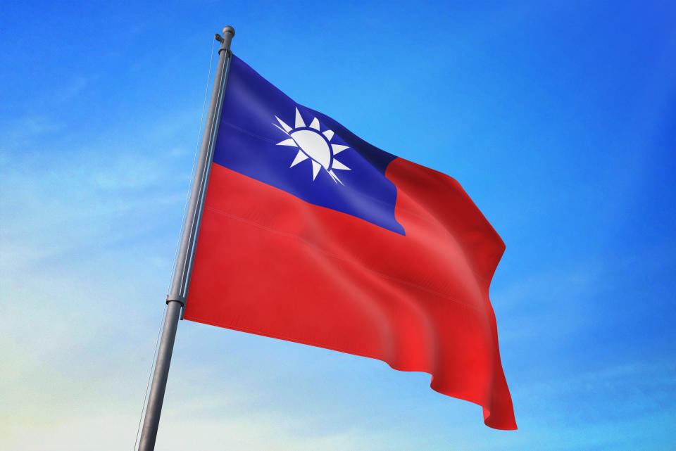 Taiwan flag waving in the blue sky in the wind