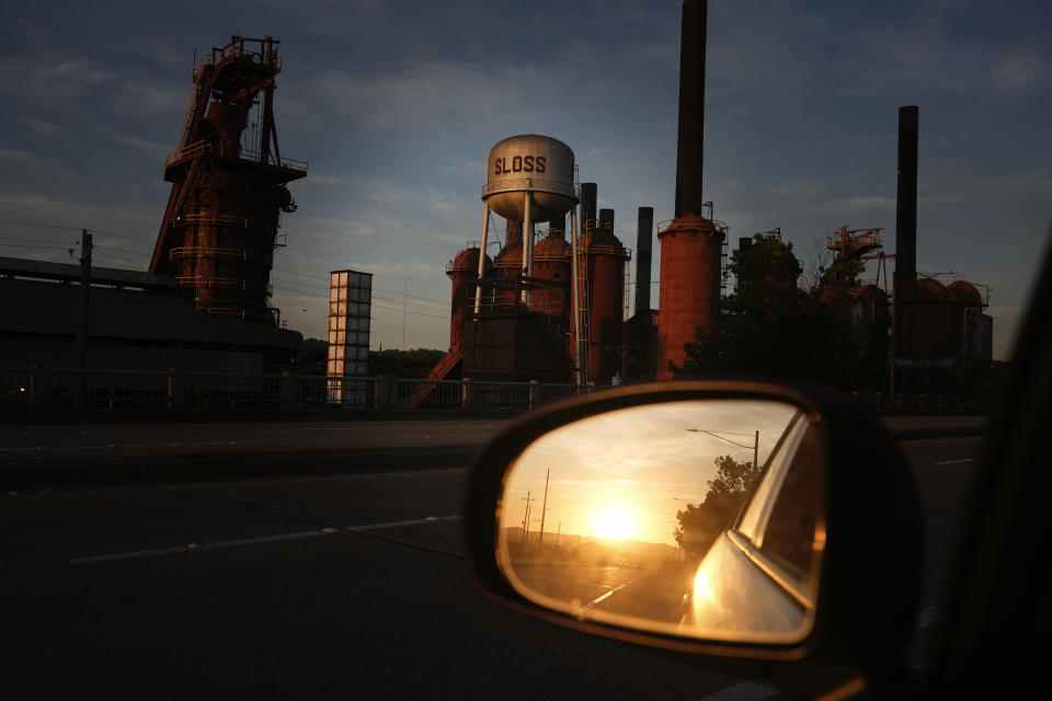 The sun rises over the horizon near the Sloss Furnaces National Historic Landmark in Birmingham, Ala, on Tuesday, June 11, 2024. Birmingham will host a regular season MLB baseball game at Rickwood Field. It's known as one of the oldest professional ballpark in the United States and former home of the Birmingham Black Barons of the Negro Leagues. The game between the St. Louis Cardinals and San Francisco Giants is set to be played on June 20, 2024. (AP Photo/Brynn Anderson)