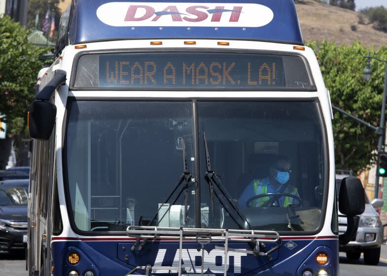 LOS ANGELES, CA - JULY 17: A bus in Chinatown encourages people to mask up. The LA County mask mandate will go into effect at 11:59 p.m. Saturday, July 17, 2021 requiring masks be worn indoors with the exception that masks can be removed if dining in a restaurant. Photographed in Chinatown on Saturday, July 17, 2021 in Los Angeles, CA. (Myung J. Chun / Los Angeles Times)