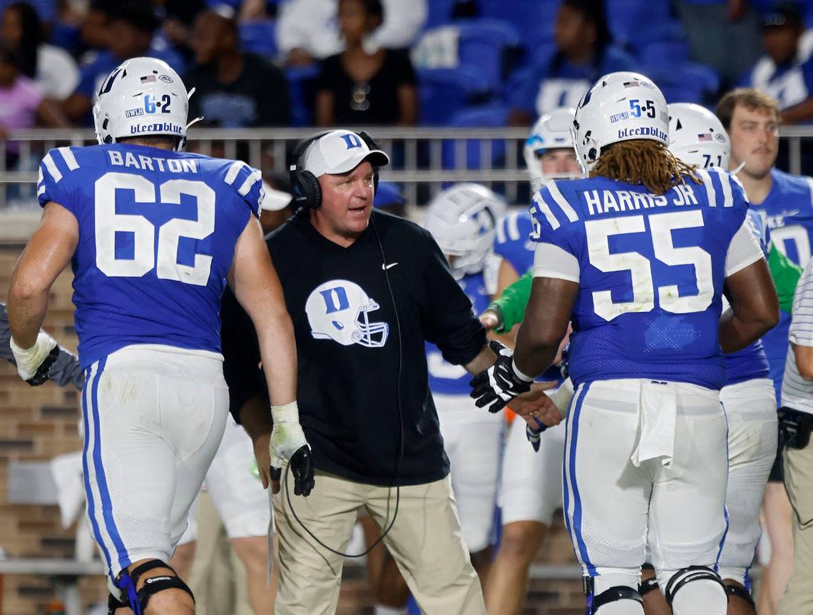 Duke head coach Mike Elko high fives players following a a touchdown during the first half of the Blue Devils season opener against Temple at Wallace Wade Stadium on Friday, Sept. 2, 2022, in Durham, N.C.