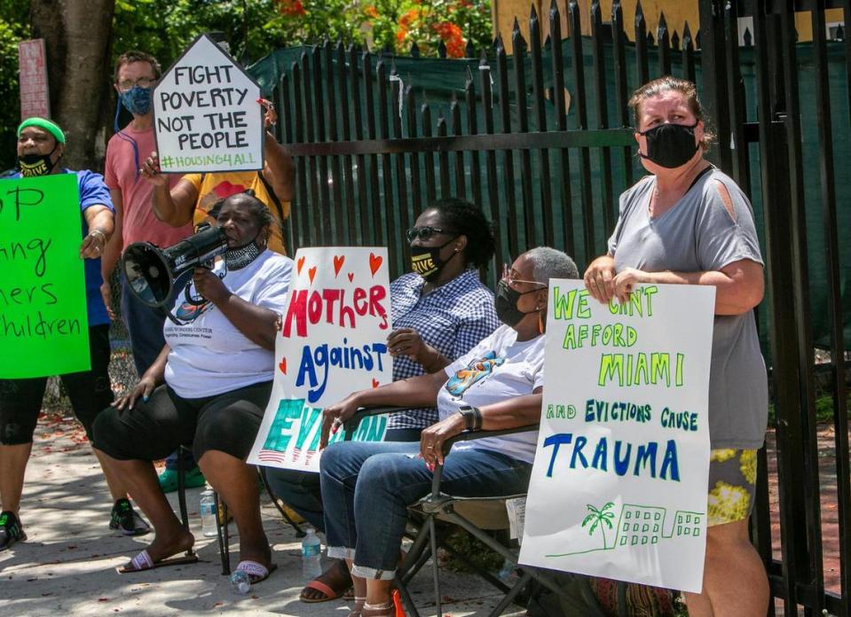 Elena Riech, right, holds a sign in protest in front of the house she rents in Allapattah along with volunteers from the Miami Workers Center who came out to support her on Tuesday, June 8. She could be evicted even though she qualified for governmental assistance because her landlord refused to accept the money.