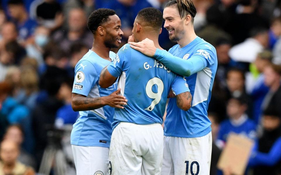 Manchester City players (L-R) Raheem Sterling, Gabriel Jesus, and Jack Grealish celebrate after winning the English Premier League - Shutterstock