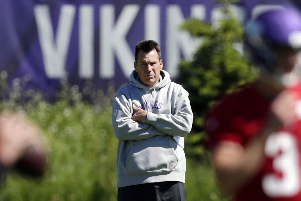 FILE - In this June 13, 2019, file photo, Minnesota Vikings assistant head coach and offensive advisor Gary Kubiak watches quarterbacks during drills at the team's NFL football training facility in Eagan, Minn. As coach Mike Zimmer prepares for his eighth season with the Minnesota Vikings, he might need to hire yet another offensive coordinator with Gary Kubiak uncertain to return. (AP Photo/Andy Clayton- King, File)