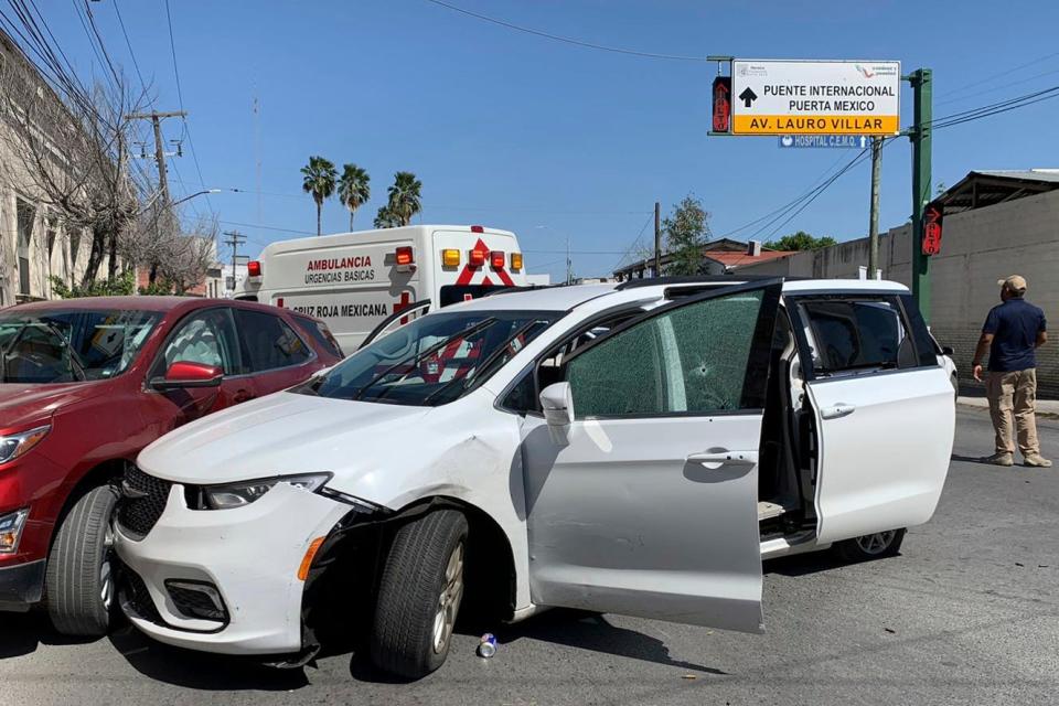 A member of the Mexican security forces stands next to a white minivan with North Carolina plates and several bullet holes, at the crime scene where gunmen kidnapped four U.S. citizens who crossed into Mexico from Texas, Friday, March 3, 2023.