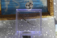 A lock of hair claimed to be from soccer legend and former Napoli player Diego Armando Maradona is displayed on a makeshift shrine dedicated to him inside the Coffee Bar Nilo in downtown Naples, Italy, Wednesday, Sept. 18, 2019. The altar inside Bar Nilo features a strand of Maradona’s hair inside a rotating, transparent box. It’s labeled “miraculous hair.” (AP Photo/Gregorio Borgia)