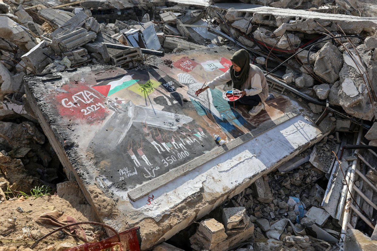 Palestinian female artist is seen drawing a picture titled 