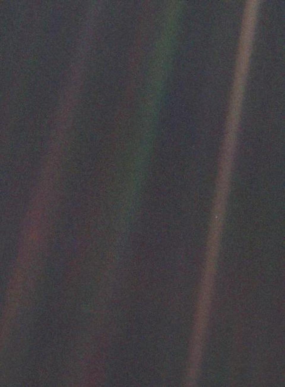 Earth is seen as a mote in an orange shaft of sunlight in this image taken by the Voyager 1 spacecraft in 1990 from a vantage point 40 times further from the Sun that the Earth. (Nasa)