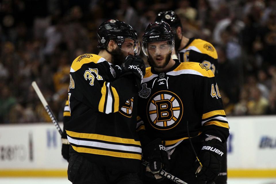 BOSTON, MA - JUNE 13:  Patrice Bergeron #37 of the Boston Bruins talks with David Krejci #46 during Game Six of the 2011 NHL Stanley Cup Final at TD Garden on June 13, 2011 in Boston, Massachusetts.  (Photo by Elsa/Getty Images)