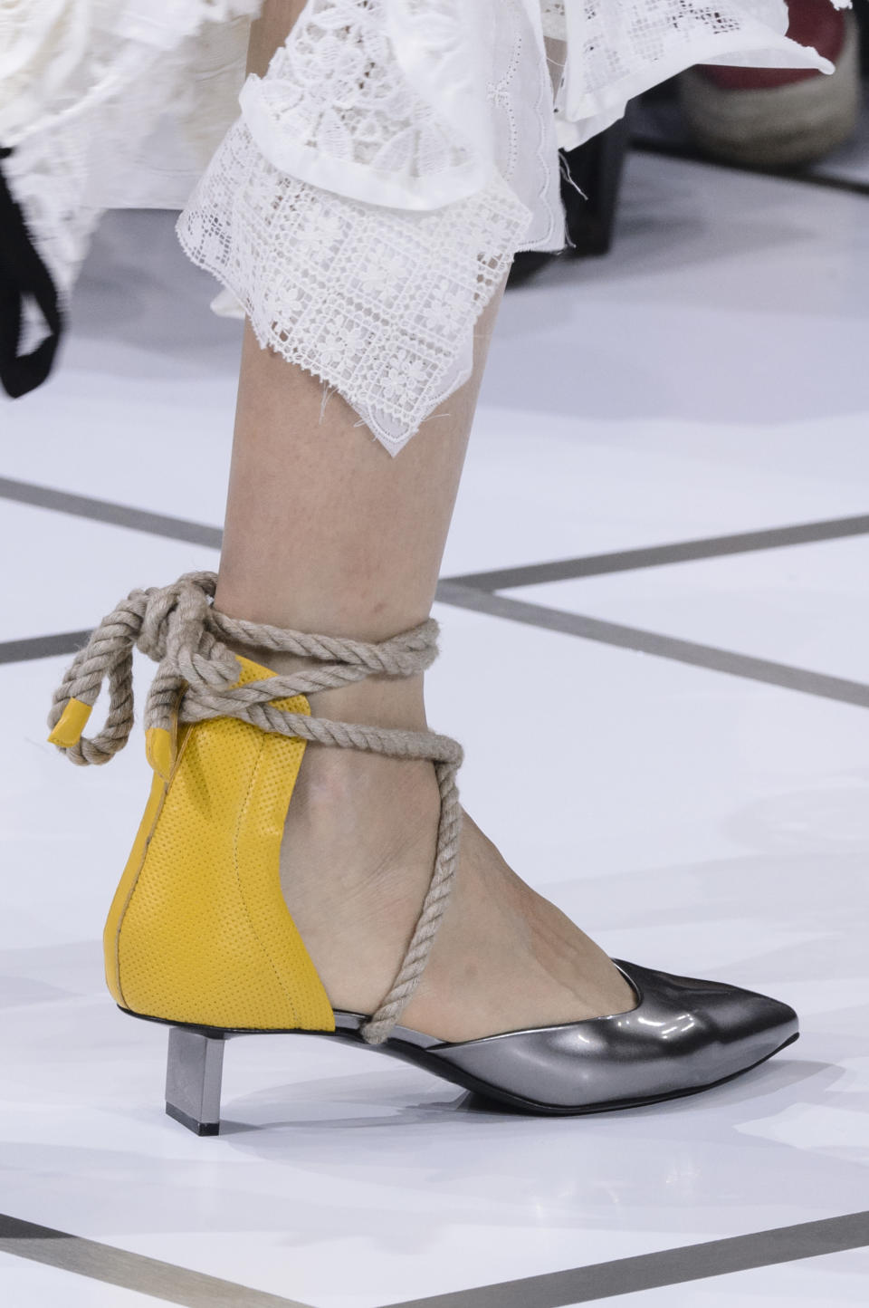 <p><i>Rope tie yellow and silver heels from the SS18 Sacai collection. (Photo: ImaxTree) </i></p>