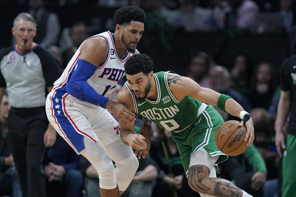 Boston Celtics forward Jayson Tatum, right, drives with the ball as Philadelphia 76ers forward Tobias Harris, left, defends during the first half of Game 7 in the NBA basketball Eastern Conference semifinal playoff series, Sunday, May 14, 2023, in Boston. (AP Photo/Steven Senne)