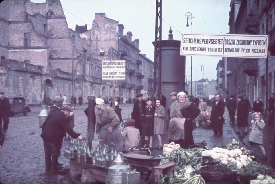 Warsaw, Nazi-occupied Poland, 1940. The signs read, "Typhus area. Passage permitted only while traveling." (Hugo Jaeger—Time & Life Pictures/Getty Images) <br> <br> <a href="http://life.time.com/history/world-war-ii-color-photos-from-nazi-occupied-poland-1939-1940/#1" rel="nofollow noopener" target="_blank" data-ylk="slk:Click here to see the full collection at LIFE.com;elm:context_link;itc:0;sec:content-canvas" class="link ">Click here to see the full collection at LIFE.com</a>