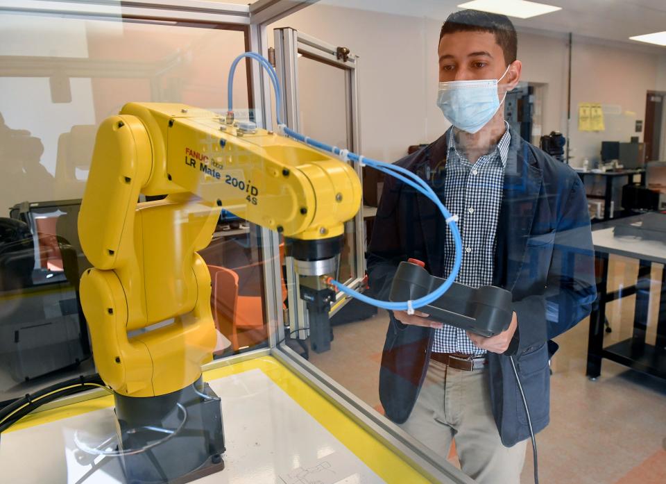 Jakob Vazquez, a student at Rowan College of South Jersey-Cumberland Campus, operates the FANUC Robot at the school's new Mechatronics Innovation Learning Lab. Learn about programs available at RCSJ's Cumberland and Gloucester campuses at upcoming open house events.