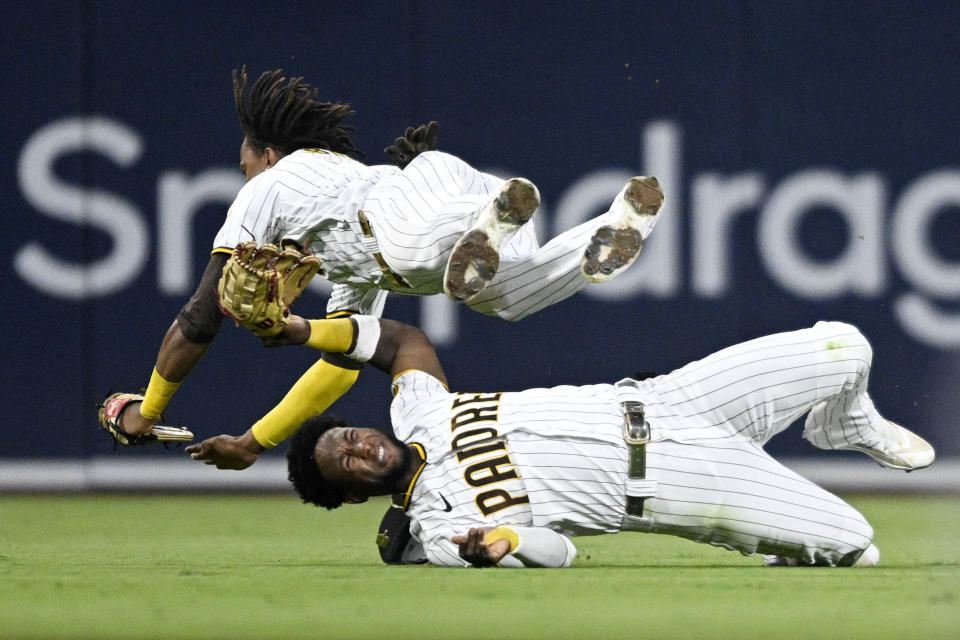 SAN DIEGO, CA - JULY 7:   C.J. Abrams #77 of the San Diego Padres (R) collides with Jurickson Profar #10 as he makes a catch on a ball hit by Tommy La Stella #8 of the San Francisco Giants during the fifth inning of a baseball game July 7, 2022 at Petco Park in San Diego, California. Profar was injured on the play. (Photo by Denis Poroy/Getty Images)