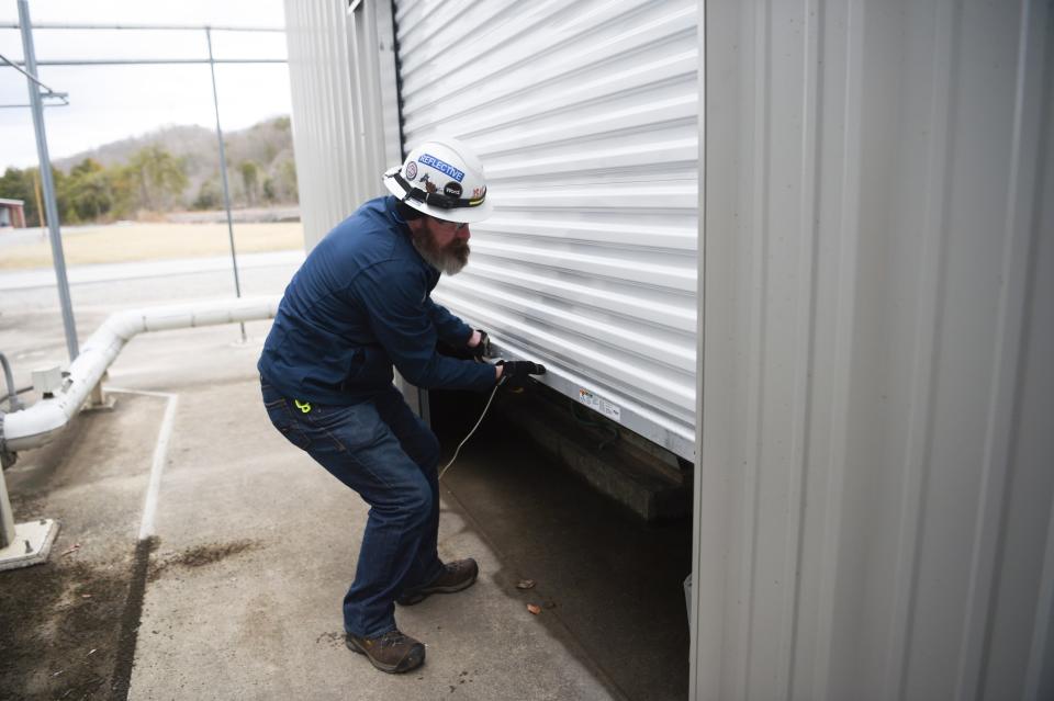 John Sevier plant operations manager Jerome Tripp opens a sheet metal structure that protects equipment at TVA’s John Sevier Combined Cycle power plant from the elements, in Rogersville.