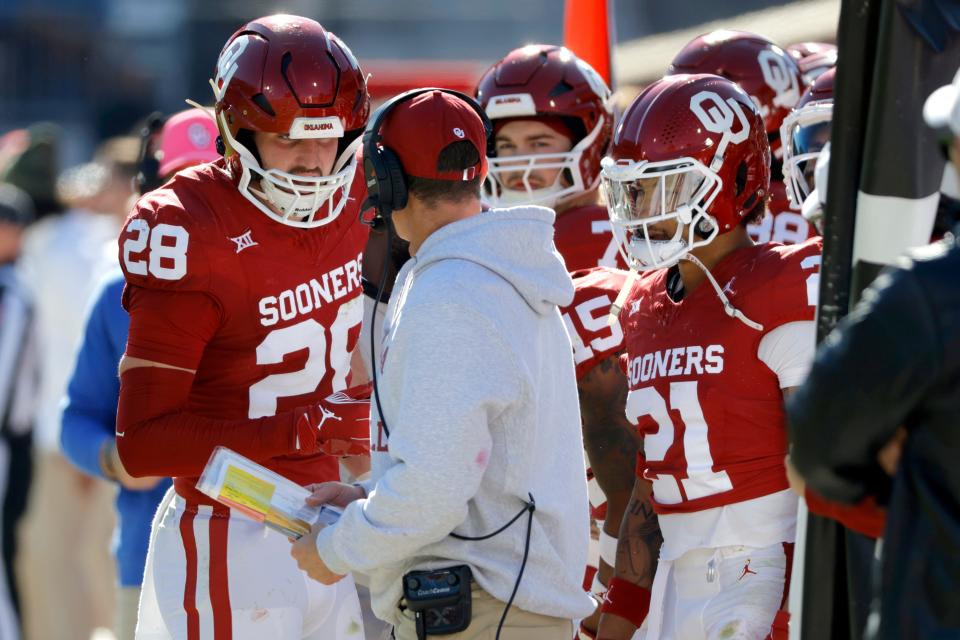 Oklahoma Sooners linebacker Danny Stutsman (28) talks with Oklahoma coach Brent Venables during a college football game between the University of Oklahoma Sooners (OU) and the TCU Horned Frogs at Gaylord Family-Oklahoma Memorial Stadium in Norman, Okla., Friday, Nov. 24, 2023. Oklahoma won 69-45.