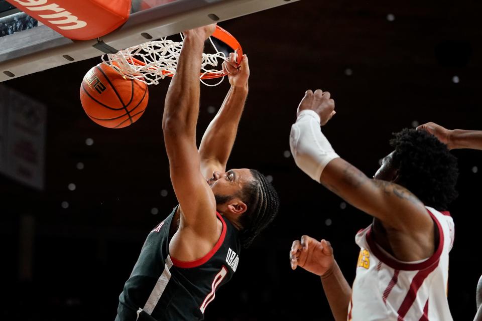 Texas Tech forward Kevin Obanor (0) dunks the ball ahead of Iowa State guard Tyrese Hunter, right, during the second half of an NCAA college basketball game, Wednesday, Jan. 5, 2022, in Ames, Iowa. (AP Photo/Charlie Neibergall) ORG XMIT: IACN1