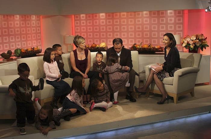 Eight individuals, including Jon & Kate Gosselin and their sextuplets, sit interactively during a TV interview