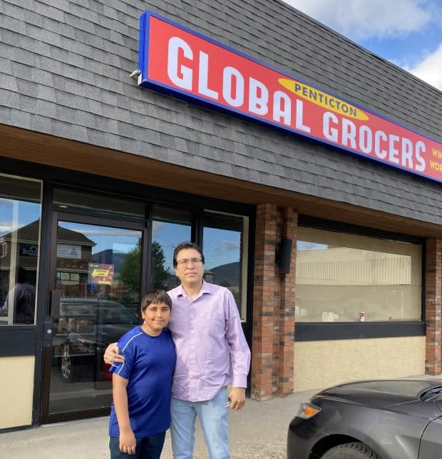 Aarav with his dad Deepak Gaba in front of the Penticton, B.C., location of Global Grocers.