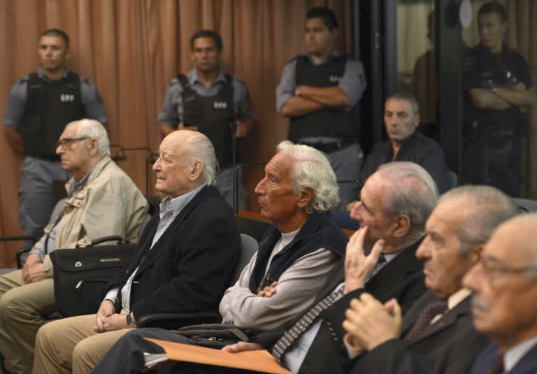 Former Argentine military members Santiago Riveros (2-L) and Eugenio Guanabens (C) are seen in Buenos Aires in 2013 among other defendants during their trials over crimes committed during Operation Condor