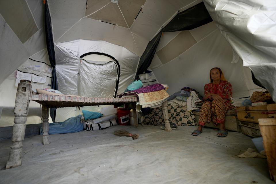 A woman sits inside her tent, in Ismail Khan Khoso village in Sohbatpur, a district of Pakistan's Baluchistan province, Thursday, May 18, 2023. (AP Photo/Anjum Naveed)