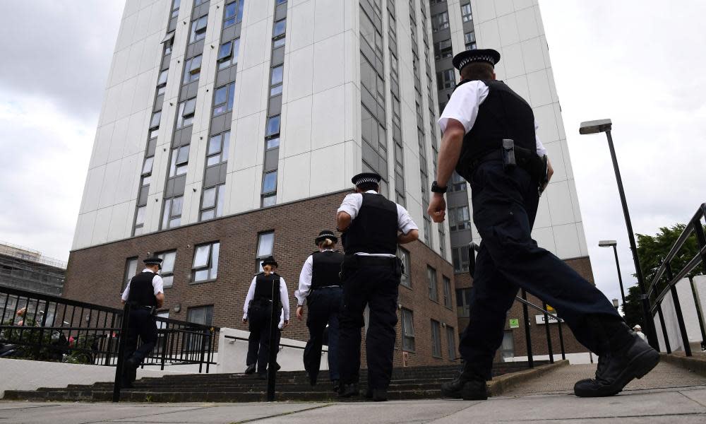 Police officers arrive at a tower block in north London from which residents are being evacuated due to fire safety fears.