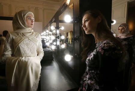 Models gather backstage before a show of the Firdaws fashion house led by Aishat Kadyrova, daughter of the Chechen Republic head Ramzan Kadyrov, at the Mercedes-Benz Fashion Week Russia in Moscow, Russia, March 17, 2017. REUTERS/Sergei Karpukhin