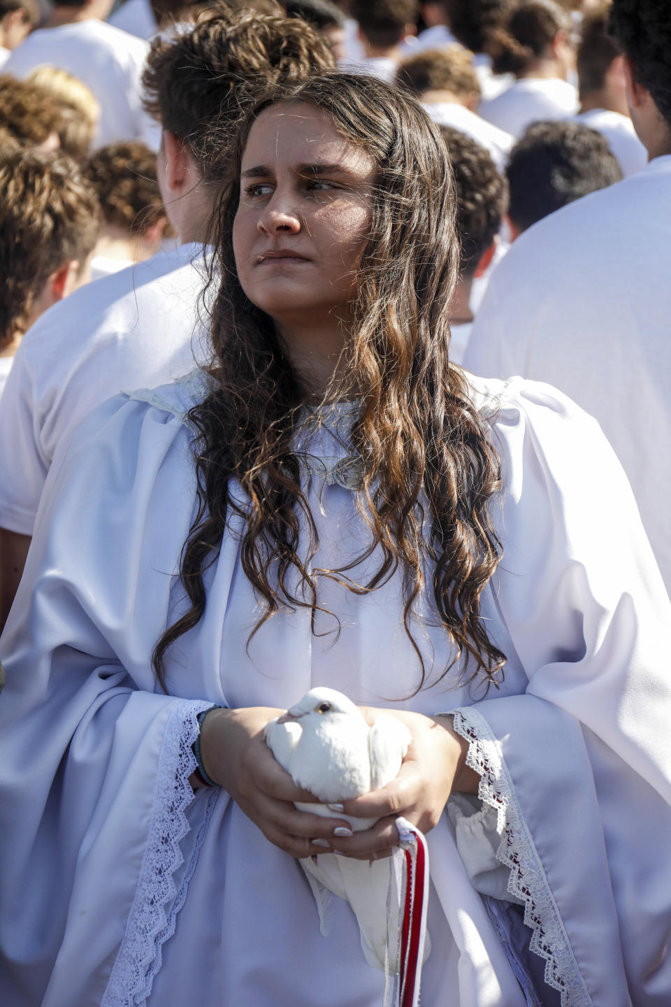 Dove bearer Chloe Kotis, 17, holds a dove in her hands during the 118th annual celebration of Epiphany at St. Nicholas Greek Orthodox Cathedral on Saturday, Jan. 6, 2024, in Tarpon Springs, Fla. (Jefferee Woo/Tampa Bay Times via AP)