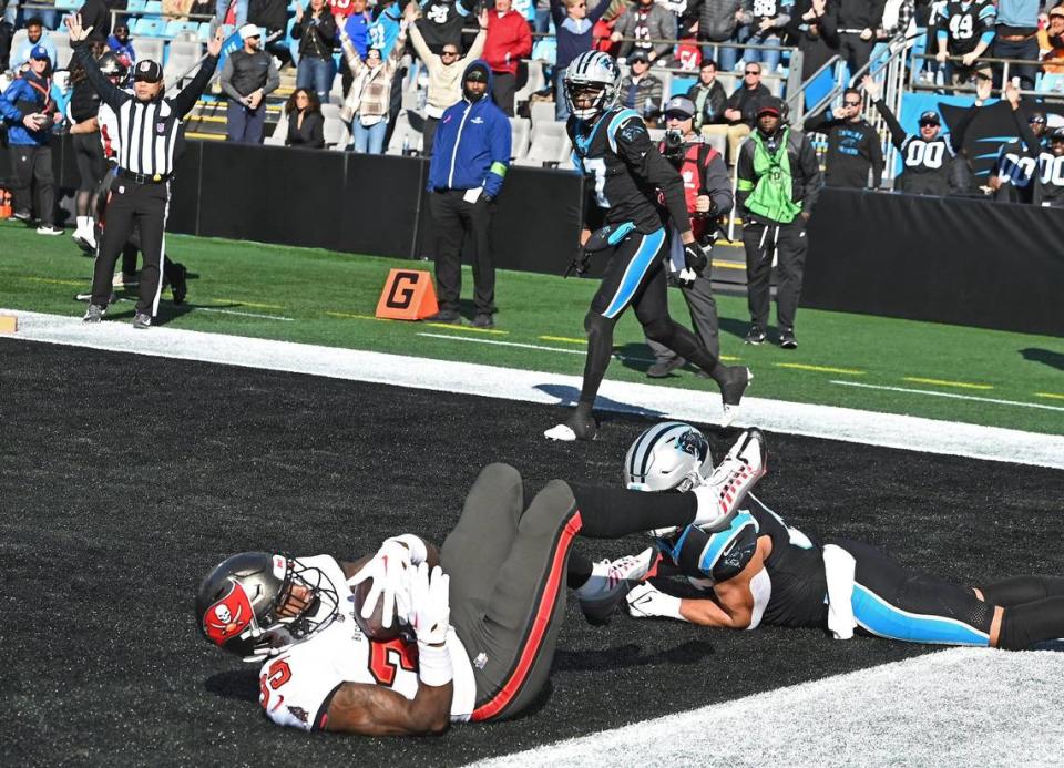 Tampa Bay Buccaneers cornerback Jamel Dean, left, recovers a fumble by Carolina Panthers wide receiver DJ Chark, center, in the end zone during second-quarter action at Bank of America Stadium in Charlotte, NC on Sunday, January 7, 2024.