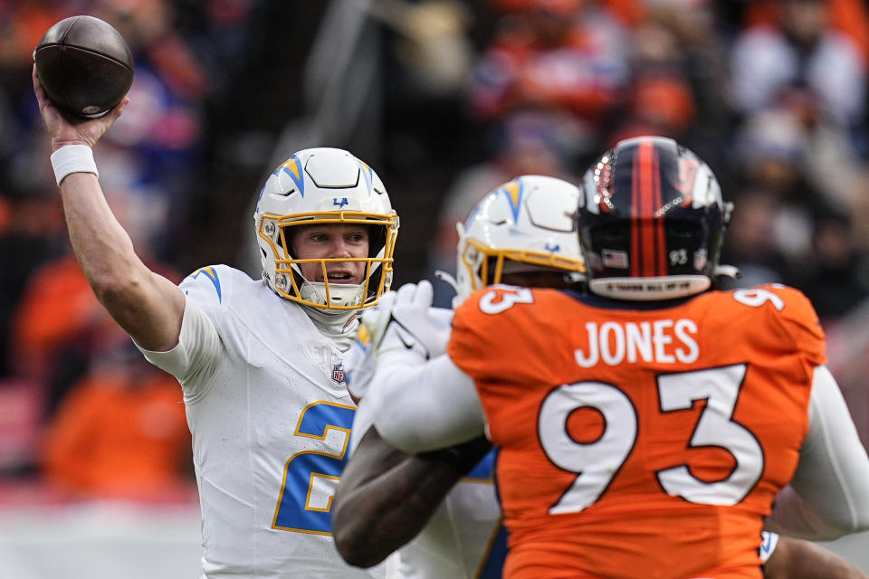 Los Angeles Chargers quarterback Easton Stick (2) works under pressure by the Los Angeles Chargers during the first half of an NFL football game, Sunday, Dec. 31, 2023, in Denver. (AP Photo/Jack Dempsey)