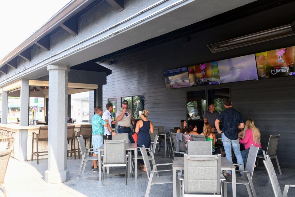 Patrons use the outdoor patio at a VIP opening of Let It Fly on Monday, July 12, at Let It Fly in Sioux Falls.