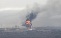 Explosion is seen over the Syrian town of Ras al-Ain as seen from the Turkish border town of Ceylanpinar