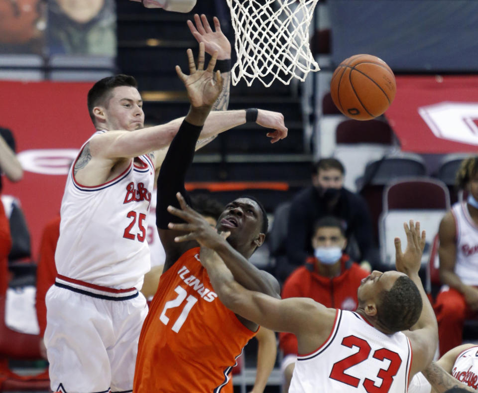 Ohio State forward Kyle Young, left, knocks the ball away from Illinois center Kofi Cockburn, center, as forward Zed Key defends during the first half of an NCAA college basketball game in Columbus, Ohio, Saturday, March 6, 2021. (AP Photo/Paul Vernon)